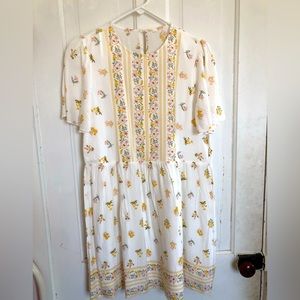 White dress with pink yellow and green floral designs